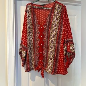 Red patterned light button down blouse.